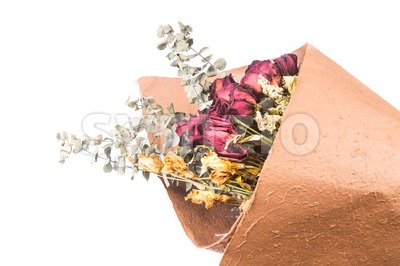 Bouquet of beautiful wrapped dried red roses and flowers. Stock Photo