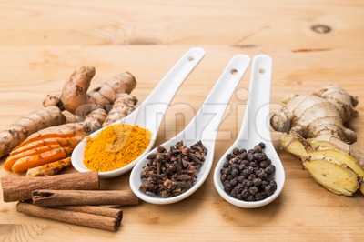 Ingredients for turmeric tea consisting ginger, cinnamon, cloves, black pepper Stock Photo
