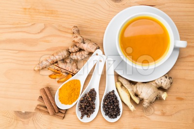 Healthy turmeric tea with black pepper, cinnamon, cloves and ginger Stock Photo