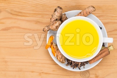 Healthy turmeric milk tea with ginger, cinnamon, cloves, black pepper Stock Photo