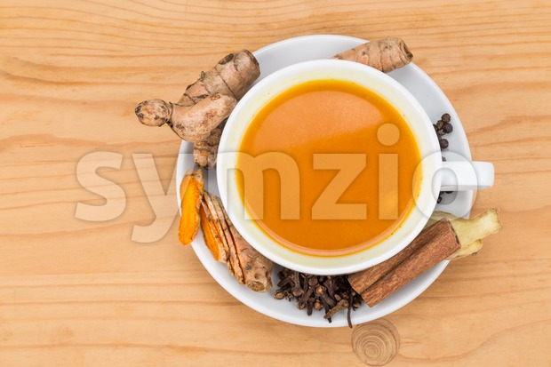 Healthy turmeric tea with black pepper, cinnamon, cloves and ginger Stock Photo