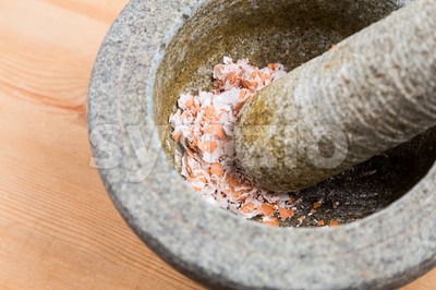 Kitchen mortar and pestle with crashed egg shell Stock Photo