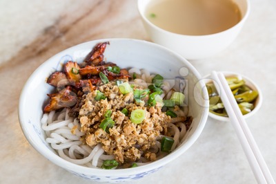 Delicious Chinese udon noodle with minced and BBQ pork Stock Photo
