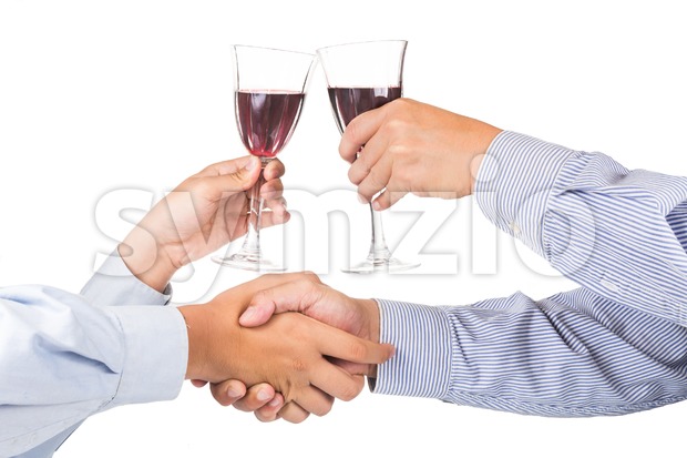 Men shaking hands and toasting red wine in crystal glass Stock Photo