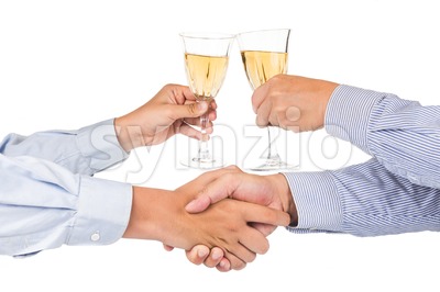 Men shaking hands and toasting white wine in crystal glass Stock Photo