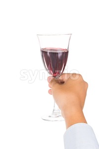 Hand holding red wine in crystal glass and ready to toast and cheers Stock Photo