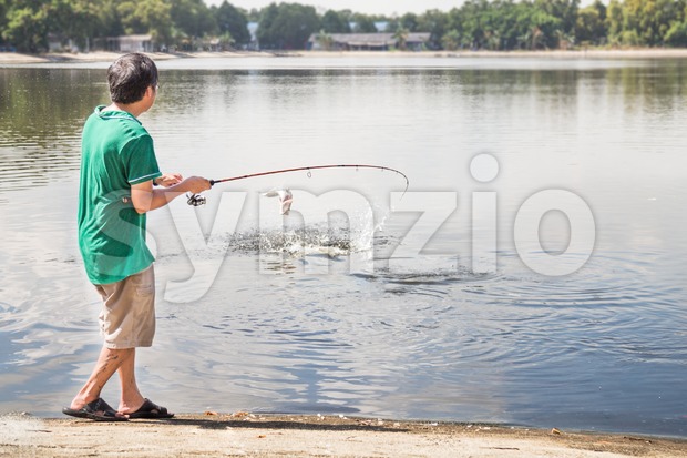 Leisure recreational fishing at a lake on a beautiful morning Stock Photo