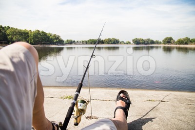 Recreational fishing at a lake with serene view in a beautiful morning Stock Photo