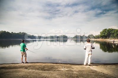 Recreational fishing at a lake with serene view  in a beautiful morning Stock Photo