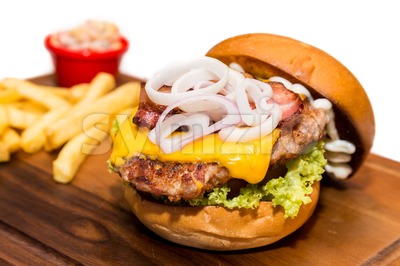 Close up on delicious Pork burger with cheese, vegetable and served with fries Stock Photo