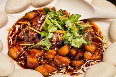 Delicious Chinese Stewed Pork Dish served with buns Stock Photo