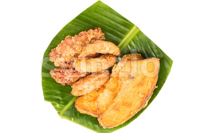 A serving consisting of the combination of fried banana (pisang goreng), fried sweet potatoes (keledek goreng) and fish nuggets (keropok lekor), a Stock Photo
