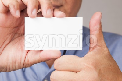 Businessman with blank placard and thumb up Stock Photo