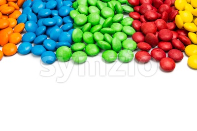 Close up colorful chocolate candy on white background with space Stock Photo