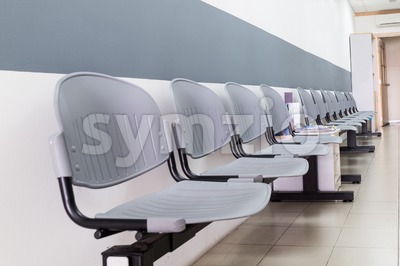 Closeup on row of empty chairs at reception of interior Stock Photo