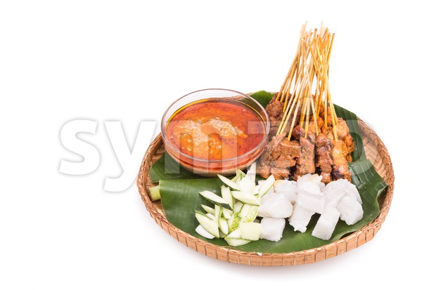 Barbecue satay served on traditional rattan plate with banana leaf Stock Photo