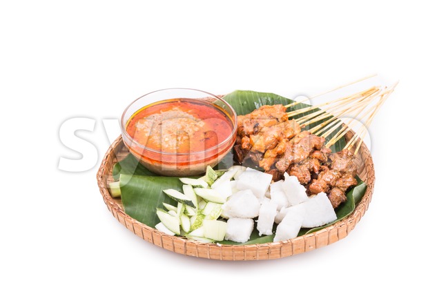 Barbecue satay served on traditional rattan plate with banana leaf Stock Photo