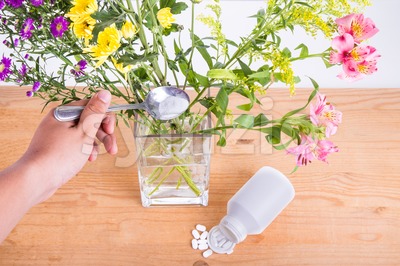 Add grounded acetylsalicylic acid tablet into vase keep flowers fresher Stock Photo