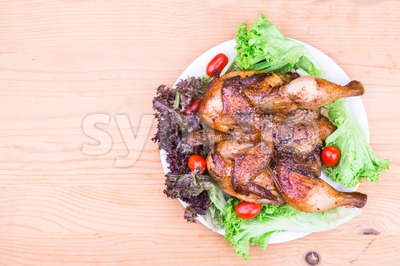 Juicy grilled roast chicken with herb, salad and tomato garnish Stock Photo