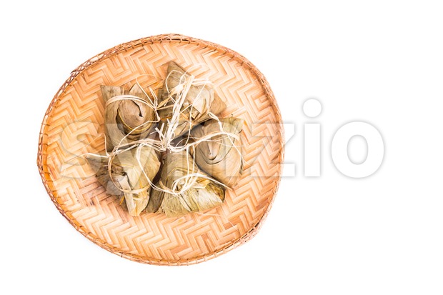 Bunch of Chinese rice dumpling placed on traditional rattan tray Stock Photo