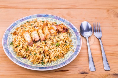 Delicious Chinese spicy fried rice with roast pork on plate Stock Photo