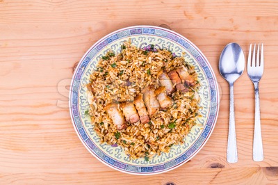 Delicious Chinese spicy fried rice with roast pork on plate Stock Photo