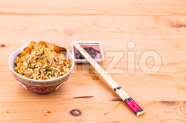 Delicious Chinese spicy fried rice with roast pork in bowl Stock Photo