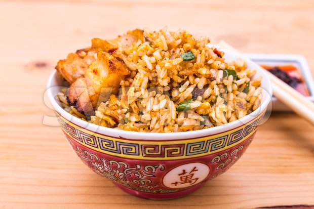 Closeup Chinese spicy fried rice with roast pork in bowl Stock Photo