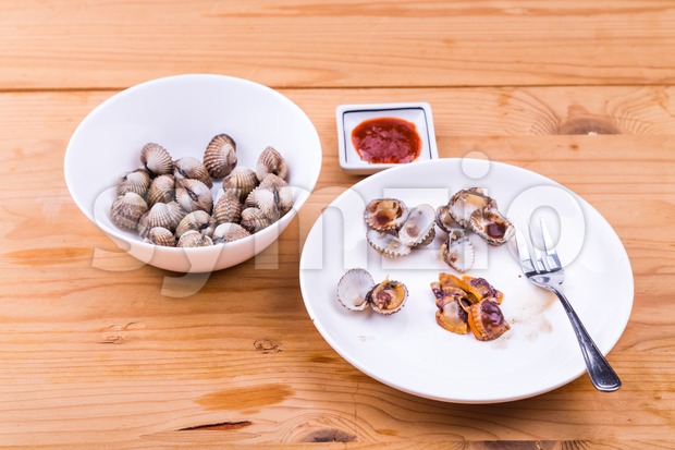 Boiled and prepared cockles with chili dip delicacy among Asians Stock Photo