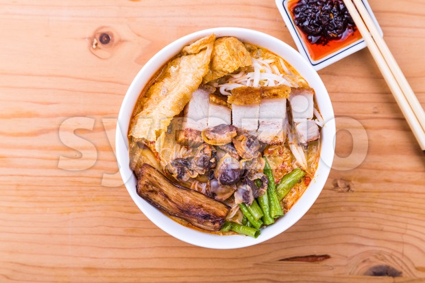 Delicious spicy curry noodle with roast pork and cockles Stock Photo
