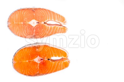 Comparison between wild and farmed salmon blocks on white background Stock Photo