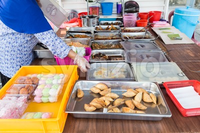 Vendor selling assorted Malay sweet cakes food at street stall Stock Photo