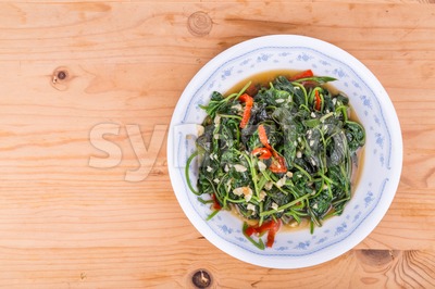 Plate of fried sweet potato leafs, delicacy among Asians Stock Photo