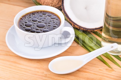 Bulletproof coffee with virgin coconut oil on wooden table Stock Photo