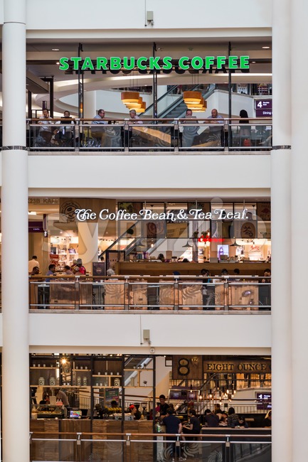 KUALA LUMPUR, MALAYSIA, May 20, 2016: Starbucks and The Coffee Bean & Tea Leafs outlets on different levels at KLCC Shopping Mall, Kuala Lumpur.  Stock Photo