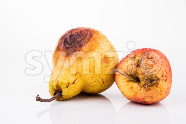 Rotten and decomposing red apple and pear on white background Stock Photo