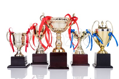 Gold trophies with decorative ribbons on white background Stock Photo