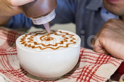 Series of person decorating coffee with art Stock Photo