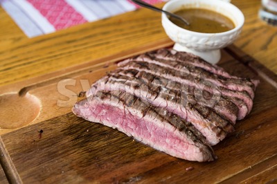 Juicy medium rare beef slice with sauce Stock Photo