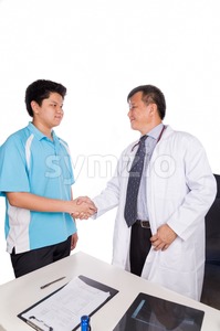 Asian patient thank and shakes hand with medical doctor Stock Photo