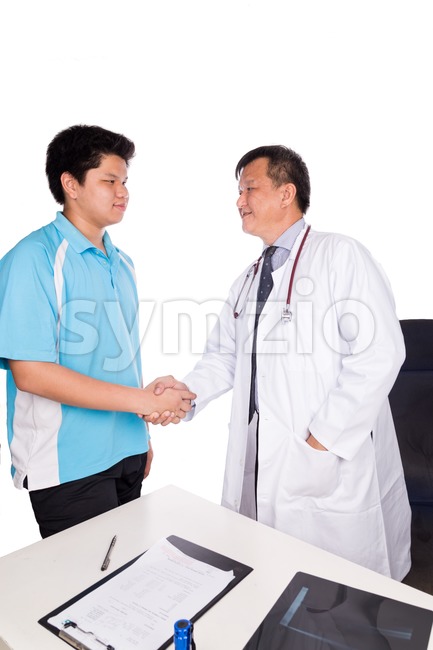 Asian patient thank and shakes hand with medical doctor Stock Photo