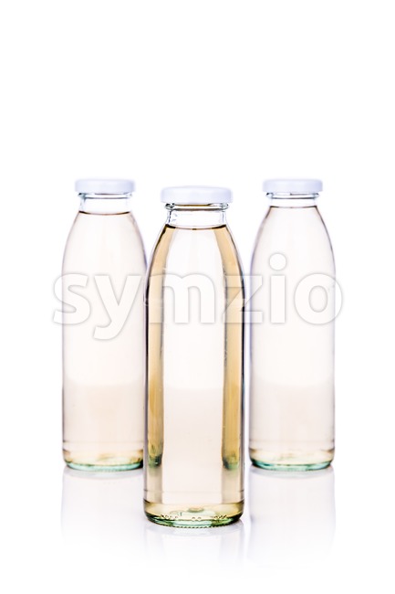 Translucent liquid in glass bottle on white background Stock Photo
