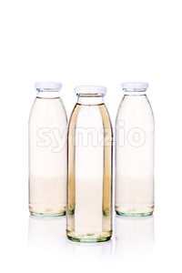 Translucent liquid in glass bottle on white background Stock Photo