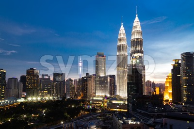 KUALA LUMPUR, MALAYSIA - JULY 23, 2016: View of the Petronas Twin Towers and KL Tower at KLCC City Center during dusk hour.  The most popular tourist Stock Photo