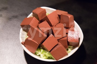 Plate of hardened pig blood in cubes, delicacy among Chinese Stock Photo