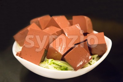 Plate of hardened pig blood in cubes, delicacy among Chinese Stock Photo