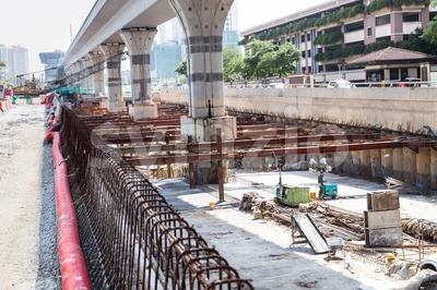 Construction of tunnel underpass beneath train line within city setting Stock Photo