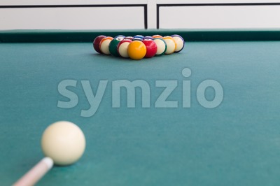 Cue aiming white ball to break snooker billards on table Stock Photo