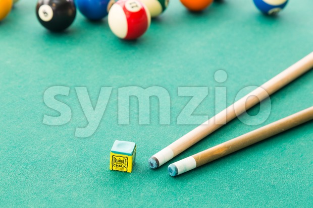 Closeup on snooker billards cue, chalk, balls on table Stock Photo