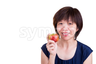 Pretty Asian women holding apple promotes healthy diet Stock Photo